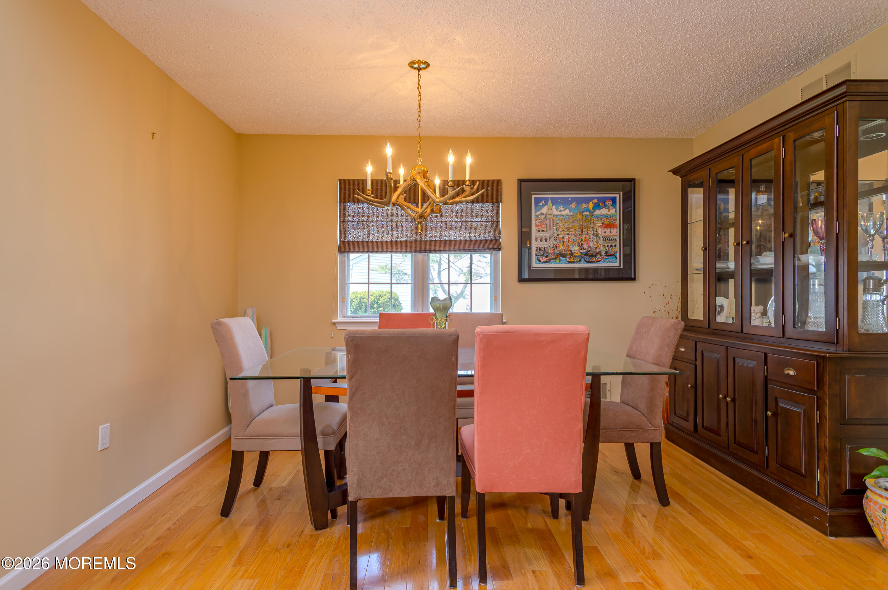 45 Datchet Close Freehold, NJ 07728 - Photo 8 of 22 a dining room with furniture a chandelier and wooden floor