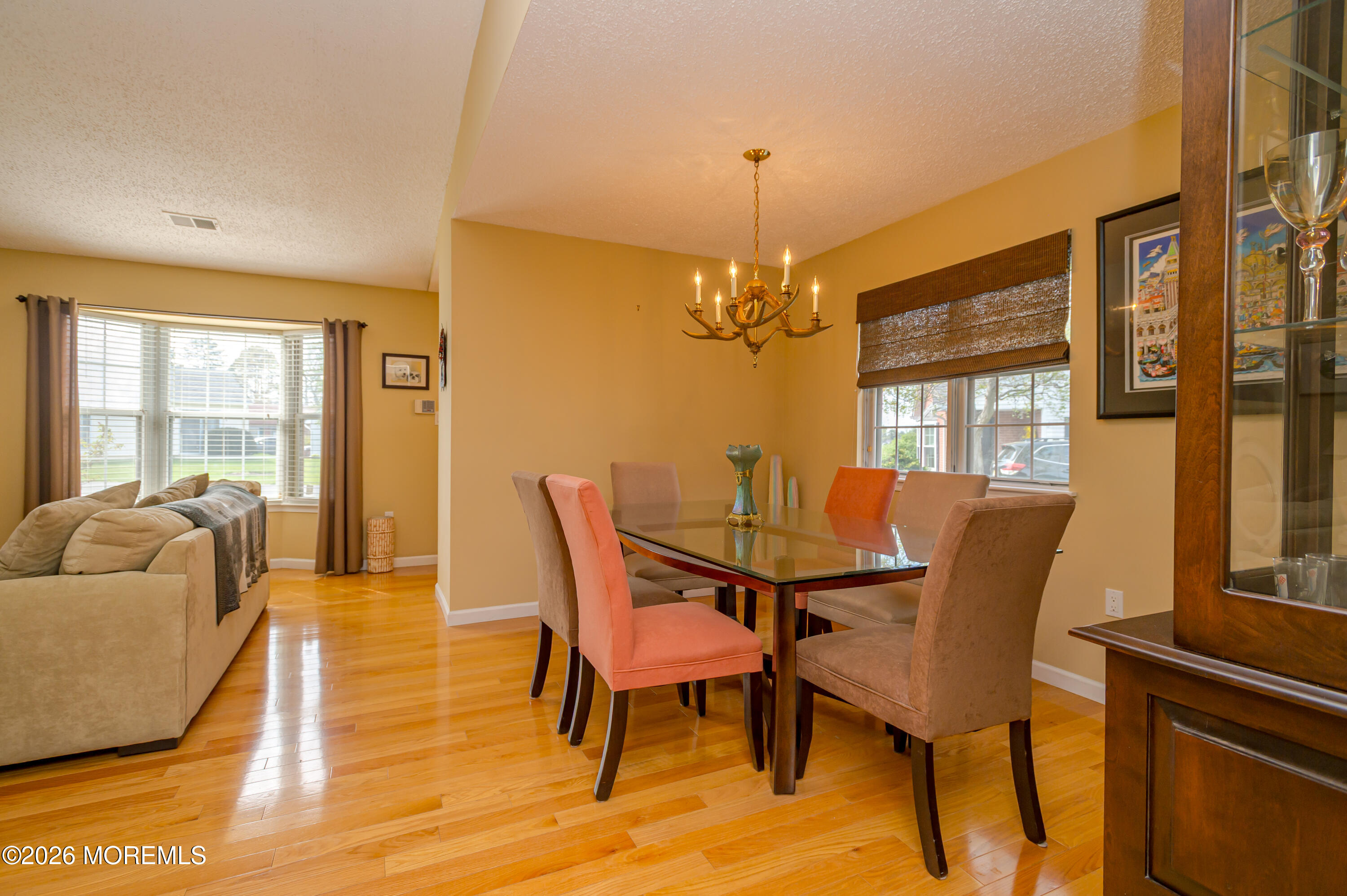 45 Datchet Close Freehold, NJ 07728 - Photo 9 of 22 a dining room with furniture a chandelier and wooden floor