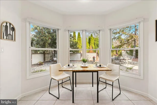 a view of a dining room with furniture large windows and wooden floor