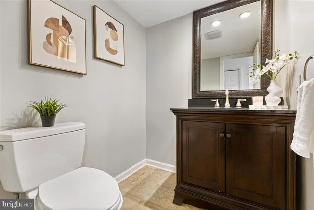 a bathroom with a toilet a sink and mirror