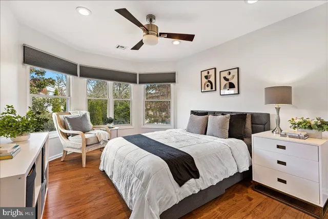 a bed room with a bed and a large window