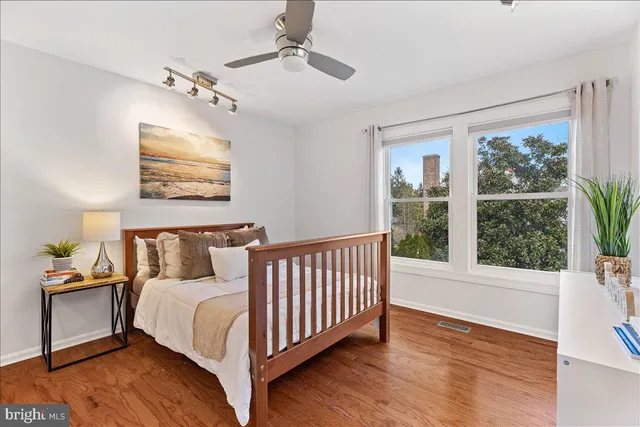 a bed sitting in a bedroom next to a window