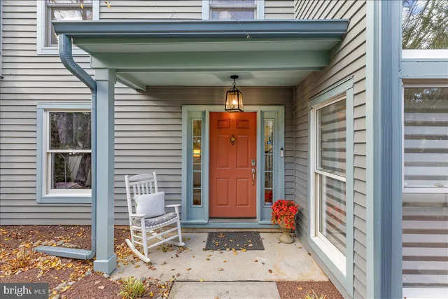 a front view of a house with red door