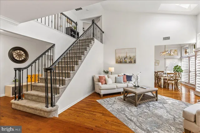a living room with chairs and a table