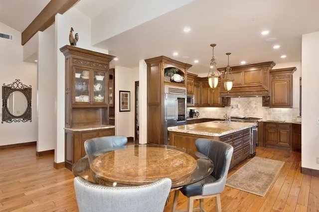 a view of a dining room with furniture large windows and wooden floor
