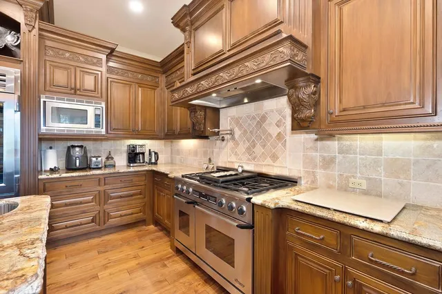 a dining room with furniture a chandelier and wooden floor