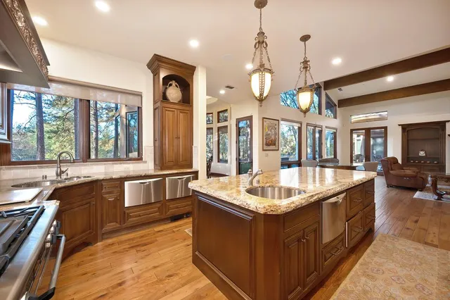 a view of a dining room with furniture large windows and wooden floor