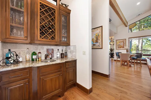 a bathroom with a granite countertop sink a large mirror and a bathtub