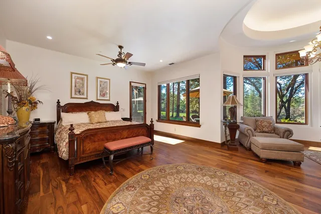a bathroom with a granite countertop sink a large mirror and a bathtub
