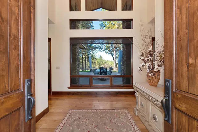 a living room with furniture fireplace and a large window