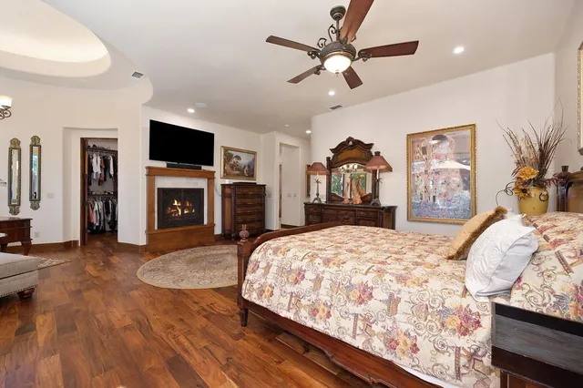 a bedroom with a large bed and a chandelier