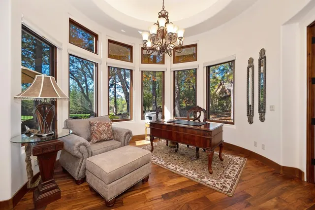 a bedroom with a bed a lamp and a chandelier