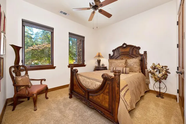 a living room with furniture and large windows