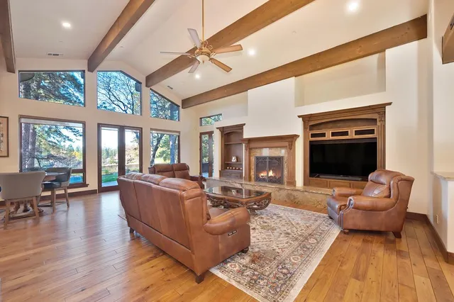 a living room with furniture a fireplace and a large window