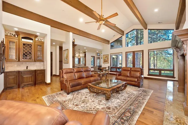 a living room with furniture fireplace and a large window