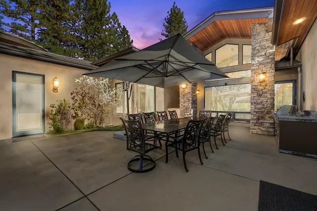 a view of a house with backyard sitting area and garden