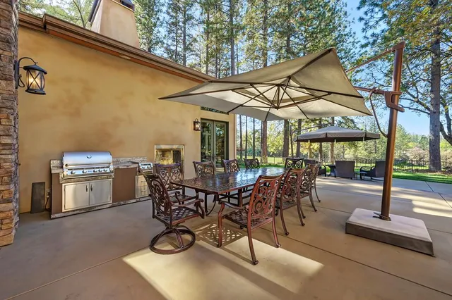 a view of a house with backyard sitting area and garden