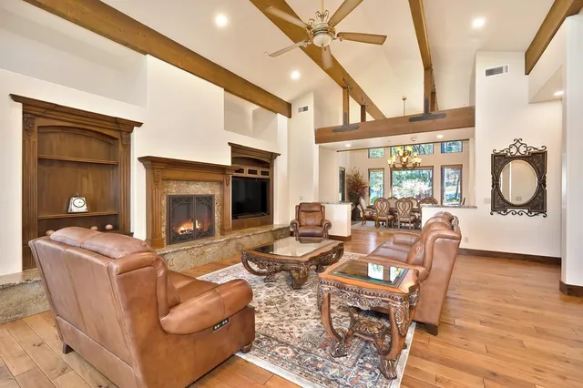 a living room with furniture a fireplace and a flat screen tv