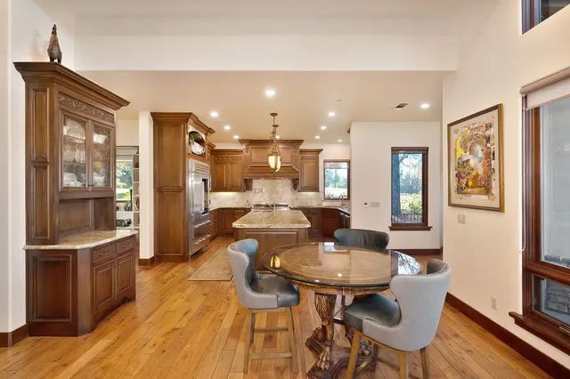 a living room with furniture a fireplace and a chandelier