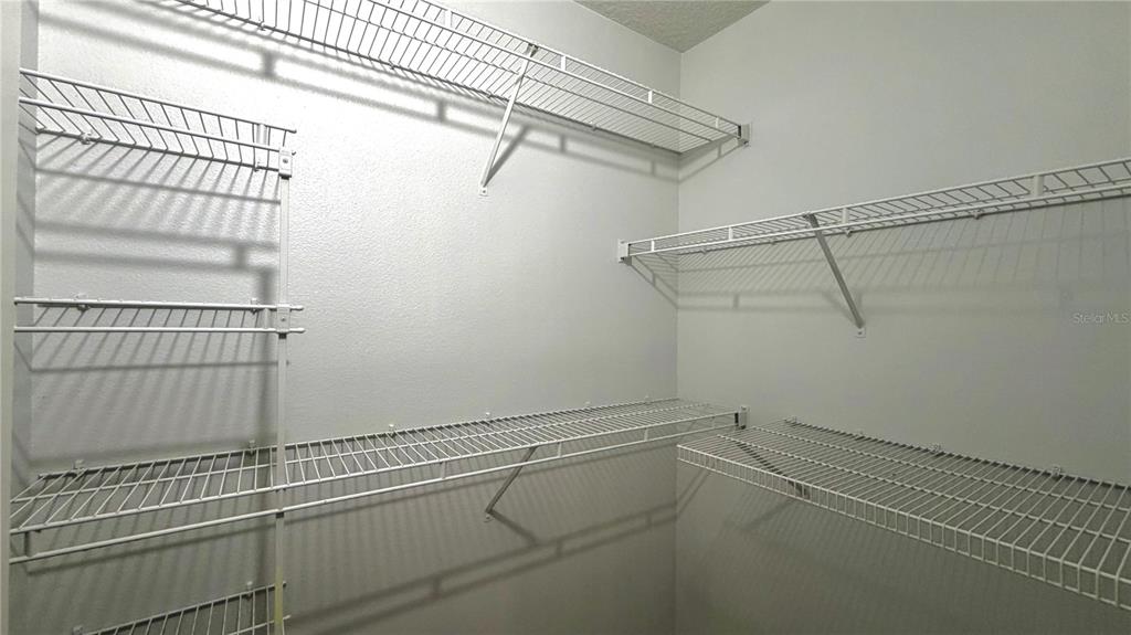 4332 South Kirkman Road, Unit 1012 Orlando, FL 32811 - Photo 12 of 20 a view of a room with racks on the wall