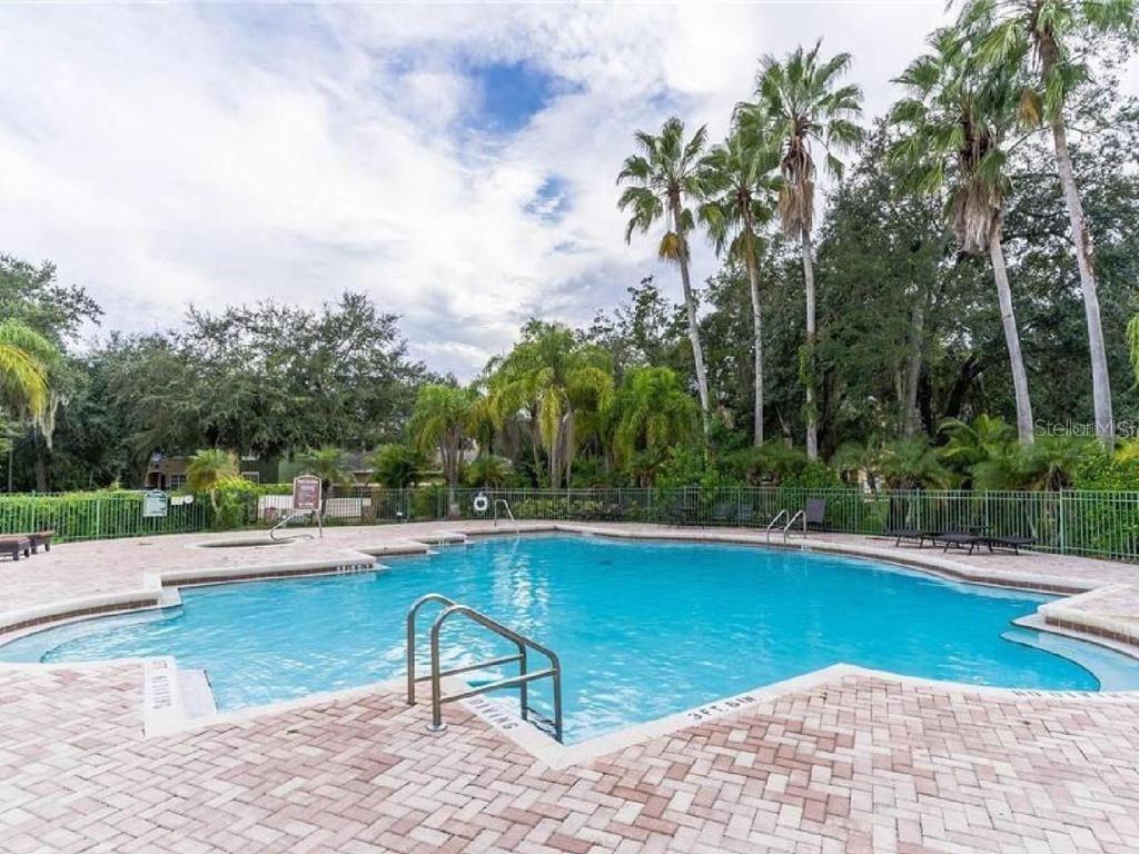 4332 South Kirkman Road, Unit 1012 Orlando, FL 32811 - Photo 16 of 20 a swimming pool with outdoor seating and yard