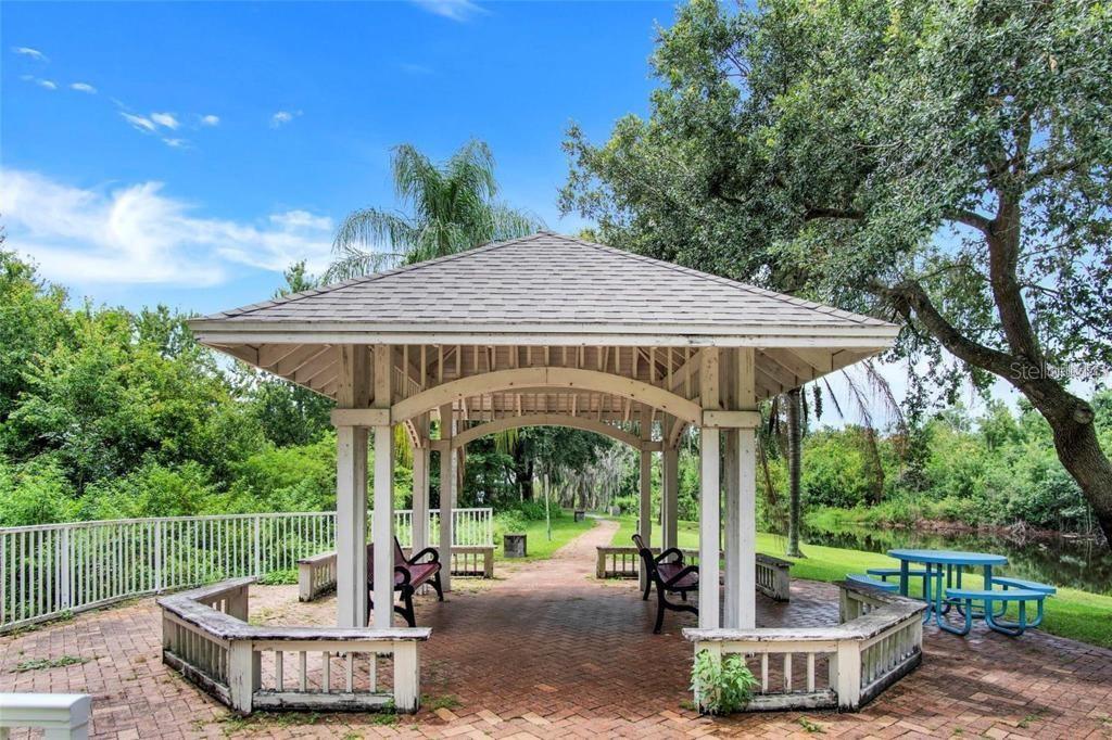 4332 South Kirkman Road, Unit 1012 Orlando, FL 32811 - Photo 18 of 20 a view of a patio with table and chairs potted plants and palm tree