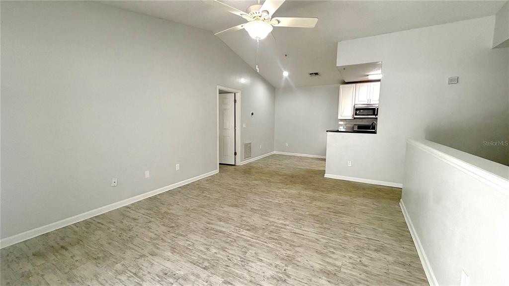 4332 South Kirkman Road, Unit 1012 Orlando, FL 32811 - Photo 3 of 20 a view of a kitchen with a sink and a refrigerator