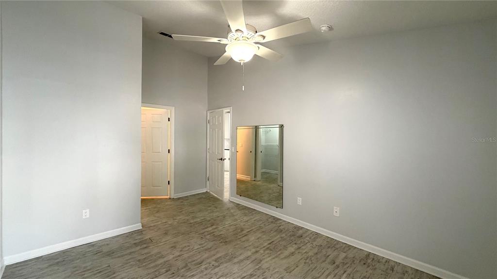 4332 South Kirkman Road, Unit 1012 Orlando, FL 32811 - Photo 5 of 20 an empty room with fan and entrance