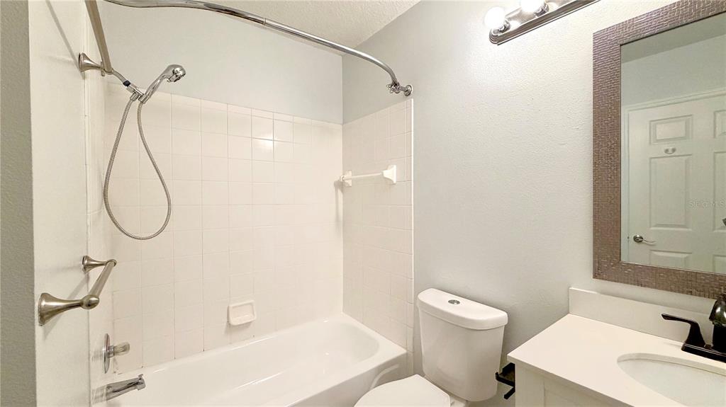4332 South Kirkman Road, Unit 1012 Orlando, FL 32811 - Photo 8 of 20 a bathroom with a sink a toilet and shower