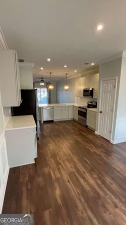 a view of a room with wooden floor and a sink