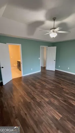 a view of empty room with wooden floor and cabinet