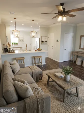 a living room with furniture and kitchen view