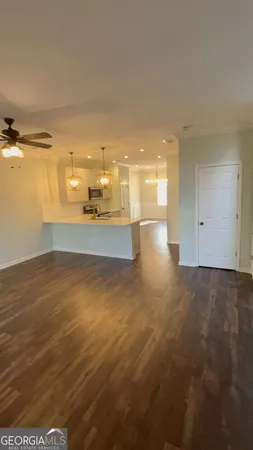 a view of a kitchen with a sink and a refrigerator