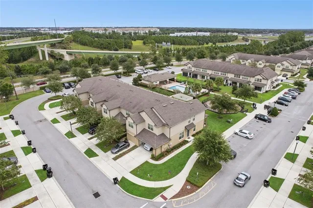 an aerial view of residential houses with outdoor space and river view