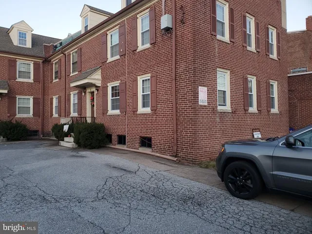 a front view of a house with parking space