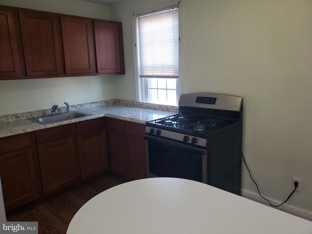 5 Winston Avenue, Unit 1 Wilmington, DE 19804 - Photo 2 of 8 a kitchen with a sink a stove and cabinets