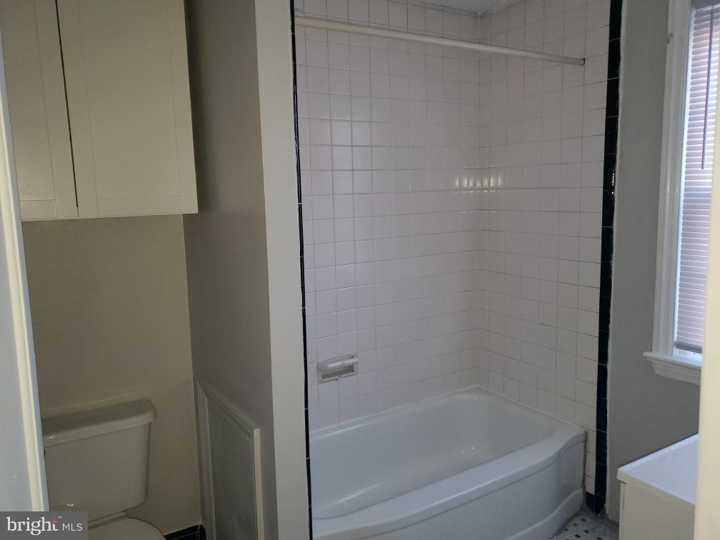 5 Winston Avenue, Unit 1 Wilmington, DE 19804 - Photo 7 of 8 a bathroom with a bathtub