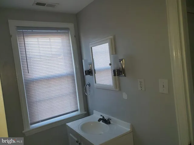 a bathroom with a sink and mirror