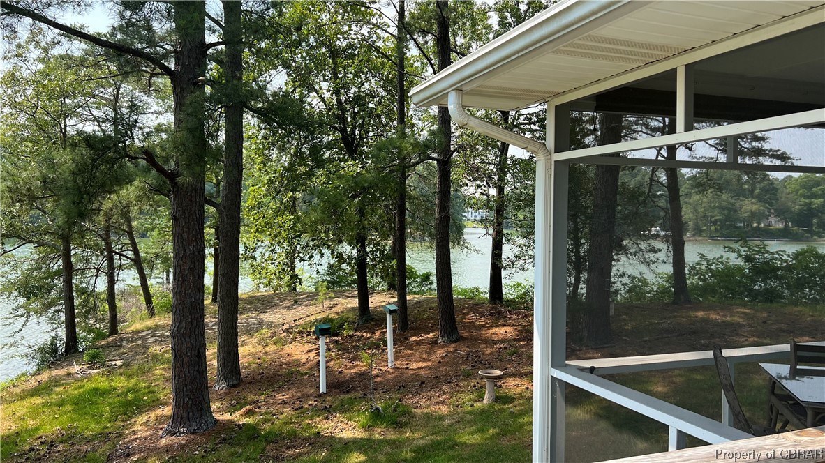 88 Leachwood Road Lancaster, VA 22503 - Photo 22 of 49 a view of a patio with table and chairs under an umbrella