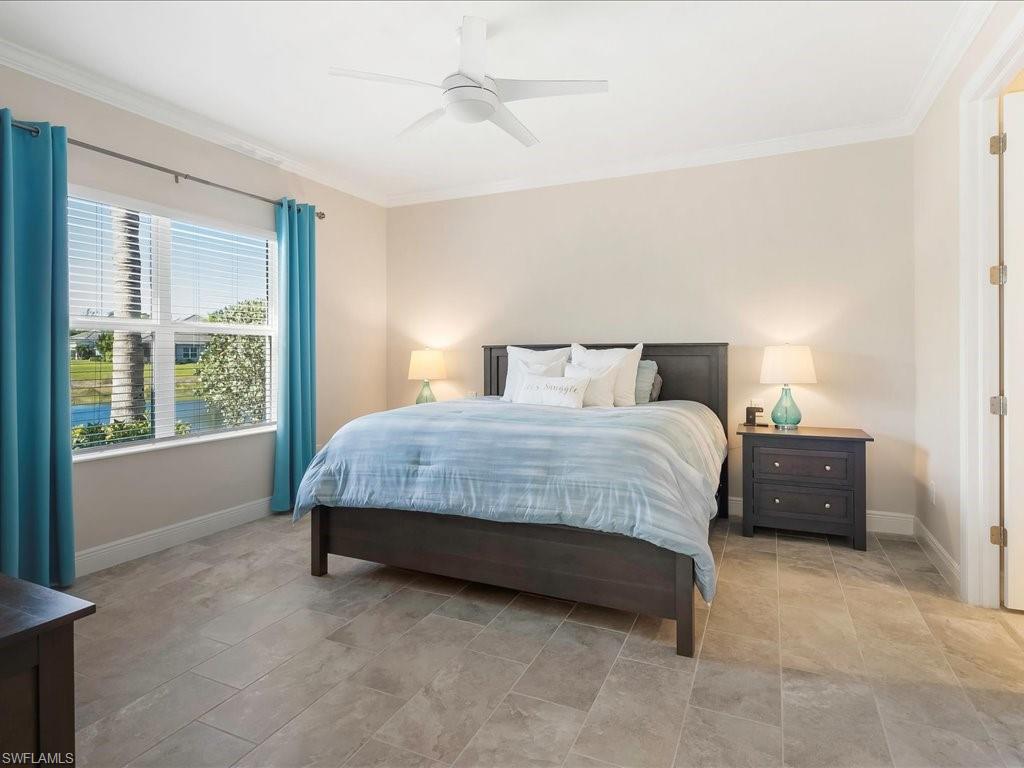 2227 Marquesa Circle Naples, FL 34112 - Photo 15 of 26 a bedroom with a bed and a large window