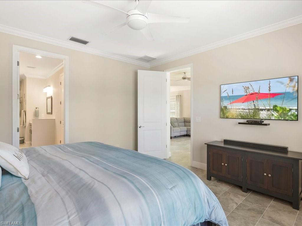 2227 Marquesa Circle Naples, FL 34112 - Photo 16 of 26 a bedroom with a bed and a flat screen tv