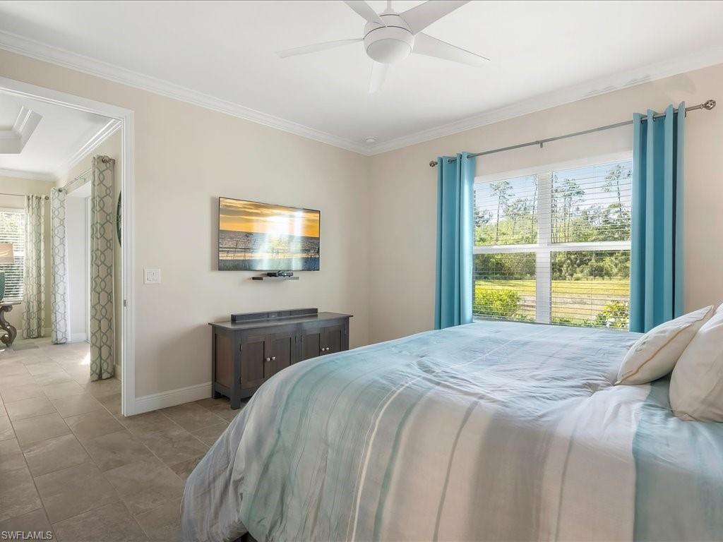 2227 Marquesa Circle Naples, FL 34112 - Photo 17 of 26 a bedroom with a bed and a window