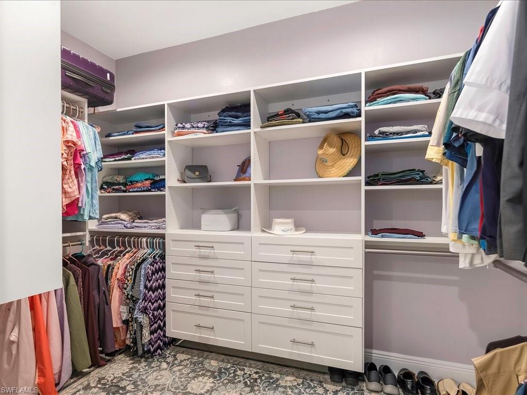 2227 Marquesa Circle Naples, FL 34112 - Photo 18 of 26 a view of walk in closet with clothes and shoes