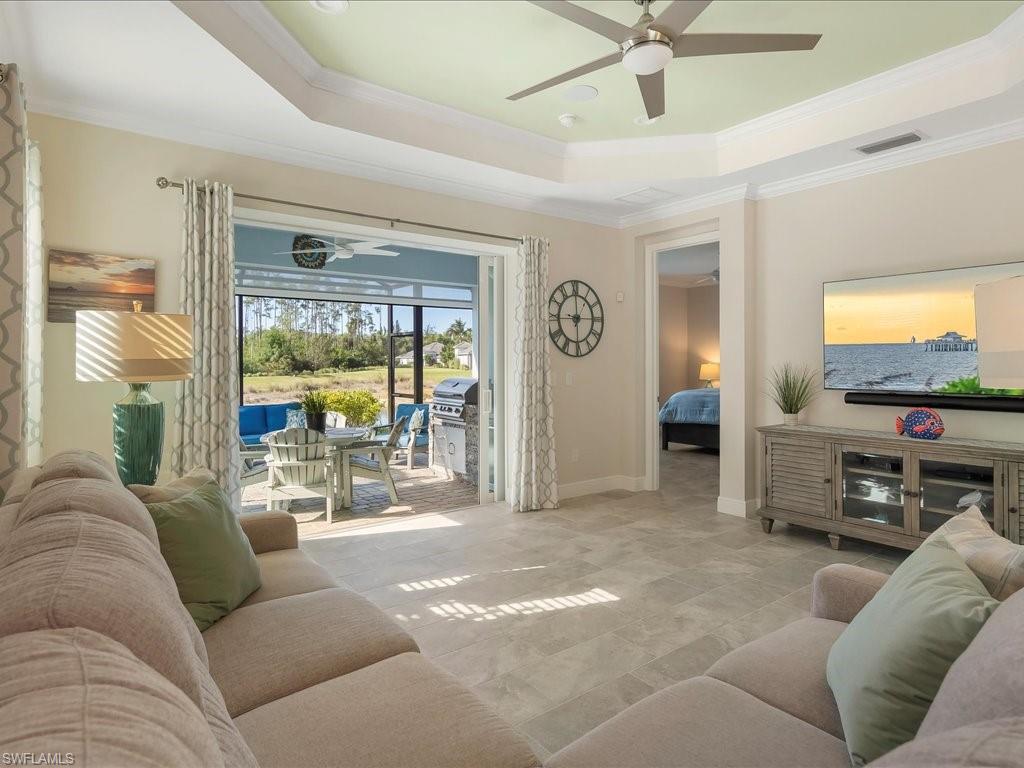 2227 Marquesa Circle Naples, FL 34112 - Photo 5 of 26 a living room with furniture and a flat screen tv