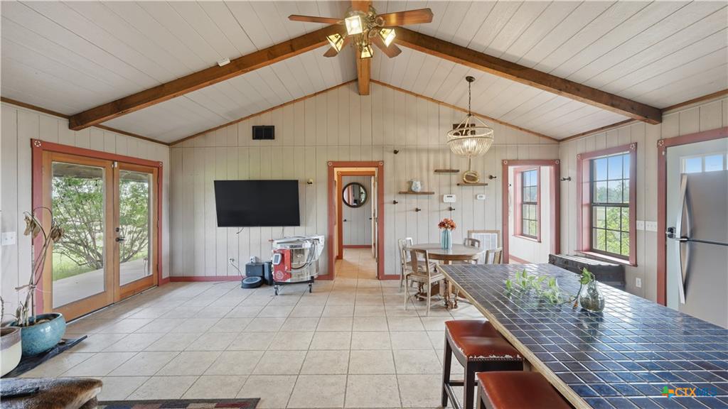 127 Offer Llano, TX 78643 - Photo 17 of 40 Vaulted planked ceiling featuring exposed wood beams and a ceiling fan