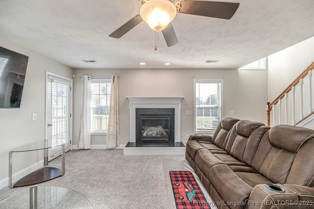 a living room with furniture a window and a fireplace