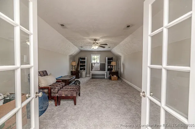 a view of a hallway with seating area