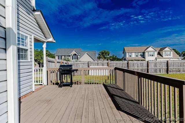 a view of a balcony with wooden floor and fence