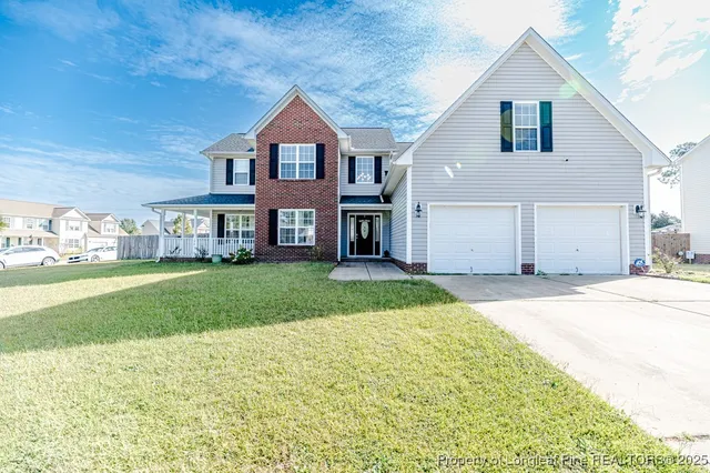 a front view of a house with a yard and garage