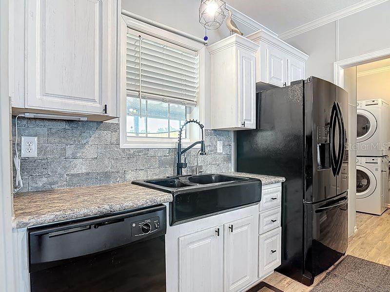 102 Ash Street Edgewater, FL 32141 - Photo 9 of 36 a kitchen with a sink stove and refrigerator